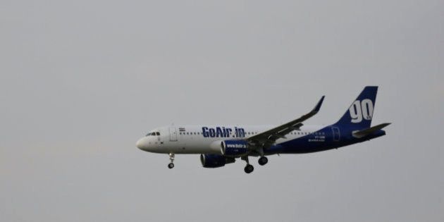 In this Thursday, April 16, 2015 photo, a passenger aircraft A320 of the GoAir Airlines prepares for landing at the Indira Gandhi International (IGI) Airport in New Delhi, India. (AP Photo/Altaf Qadri)