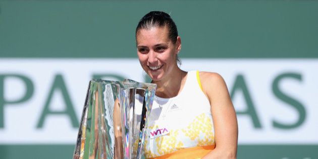 INDIAN WELLS, CA - MARCH 16: Flavia Penneta of Italy poses with the trophy following her WTA women's final victory over Agnieszka Radwanska of Poland during the BNP Paribas Open at Indian Wells Tennis Garden on March 16, 2014 in Indian Wells, California. (Photo by Jeff Gross/Getty Images)