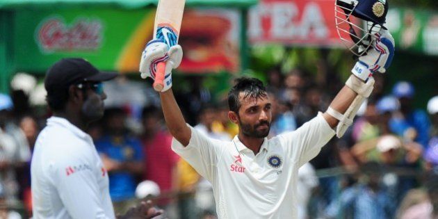Indian cricketer Ajinkya Rahane raises his bat and helmet in celebration after scoring a century (100 runs) during the fourth day of the second Test match between Sri Lanka and India at the P. Sara Oval Cricket Stadium in Colombo on August 23, 2015. AFP PHOTO / LAKRUWAN WANNIARACHCHI (Photo credit should read LAKRUWAN WANNIARACHCHI/AFP/Getty Images)