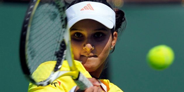 Sania Mirza of India, returns a shot to Mariya Koryttseva of Ukraine, during a first round match at the BNP Paribas Open tennis tournament, Thursday, March 12, 2009, in Anaheim, Calif. (AP Photo/Mark J. Terrill)