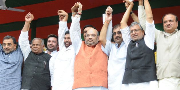 PATNA, INDIA - JULY 16: BJP Chief Amit Shah with LJP Chief Ram Vilas Paswan, HAM Chief Jitan Ram Manjhi, BJP leader Sushil Kumar Modi and other NDA leaders flagging off the 'Parivartan Rath at Gandhi Maidan on July 16, 2015 in Patna, India. These chariots will travel to all the villages spread covering 243 assembly seats of Bihar ahead of July 25 rally of Prime Minister Narendra Modi in Muzaffarpur. The party plans to hold 100,000 meetings in 100 days ahead of the elections. (Photo by AP Dube/Hindustan Times via Getty Images)