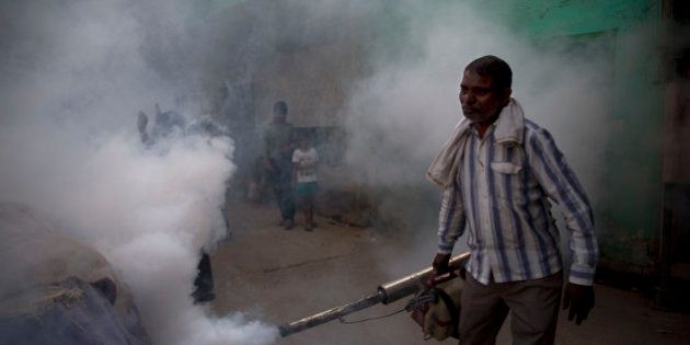 A municipal worker fumigates a residential area to prevent mosquitoes from breeding in New Delhi, India, Monday, Sept. 7, 2015. With several cases of Dengue fever, a mosquito-borne disease, being reported across the capital, the civic authorities are taking precautions to contain the disease. (AP Photo/Tsering Topgyal)