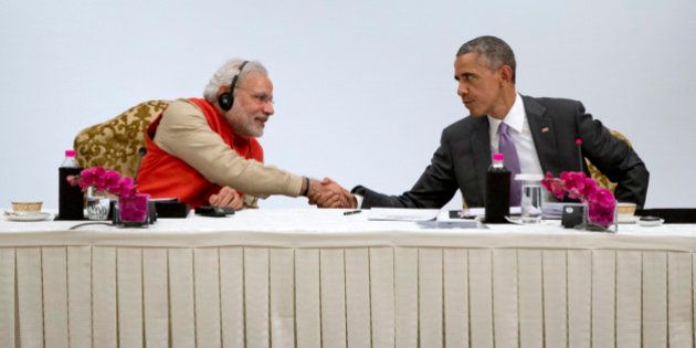 U.S President Barack Obama, right, shakes hands with Indian Prime Minister Narendra Modi as they participate in a CEO roundtable discussion at the The Taj Mahal Hotel in New Delhi, India, Monday, Jan. 26, 2015. Officials in both countries say Obama and Modi developed an easy chemistry when they first met in Washington last fall. The two leaders spent several hours together Sunday and heralded their close relationship. (AP Photo/Carolyn Kaster)