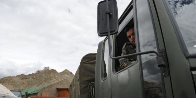 An Indian soldier sits in one of the army trucks used to transport government-provided relief materials to Leh on August 15, 2010. Some 189 were reported killed and more than 400 are still missing as overnight flash floods hit the remote Himalayan town August 6. AFP PHOTO/TENGKU BAHAR (Photo credit should read TENGKU BAHAR/AFP/Getty Images)