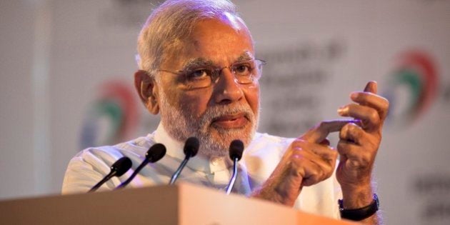 Indian Prime Minister Narendra Modi, makes a gesture of dialing phone as he addresses people during the launch of digital India project in New Delhi, India, Wednesday, July 1, 2015. The initiative involves creating opportunities for all Indian citizens by harnessing digital technologies, to empower every citizen with access to digital services, knowledge and information. (AP Photo/Saurabh Das)