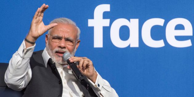 Narendra Modi, India's prime minister, left, speaks at Facebook Inc. headquarters in Menlo Park, California, U.S., on Sunday, Sept. 27, 2015. Prime Minister Modi plans on connecting 600,000 villages across India using fiber optic cable as part of his 'dream' to expand the world's largest democracy's economy to $20 trillion. Photographer: David Paul Morris/Bloomberg via Getty Images