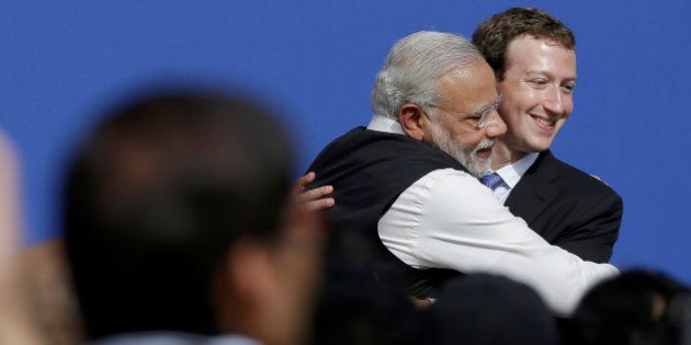 Facebook CEO Mark Zuckerberg, right, hugs Prime Minister of India Narendra Modi at Facebook in Menlo Park, Calif., Sunday, Sept. 27, 2015. A rare visit by Indian Prime Minister Narendra Modi this weekend has captivated his extensive fan club in the area and commanded the attention of major U.S. technology companies eager to extend their reach into a promising overseas market. (AP Photo/Jeff Chiu)