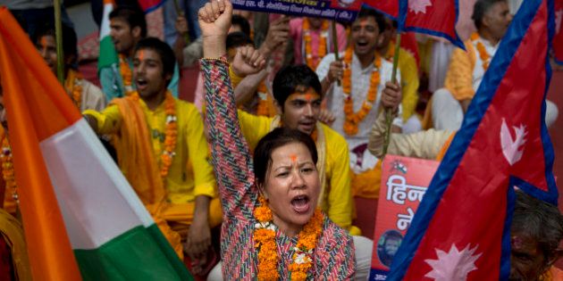 A Nepali woman shouts slogans during a protest against the Nepalese government and demanding it be restored as a Hindu nation, in New Delhi, India, Tuesday, Sept. 22, 2015. Nepal says protests against its new constitution formally adopted on Sept. 20, 2015, are abating, just hours after police opened fire on a crowd and injured three in the east of the Himalayan nation. (AP Photo/Tsering Topgyal)