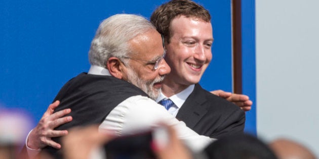 Narendra Modi, India's prime minister, left, and Mark Zuckerberg, chief executive officer of Facebook Inc., embrace at the conclusion of a town hall meeting at Facebook headquarters in Menlo Park, California, U.S., on Sunday, Sept. 27, 2015. Prime Minister Modi plans on connecting 600,000 villages across India using fiber optic cable as part of his 'dream' to expand the world's largest democracy's economy to $20 trillion. Photographer: David Paul Morris/Bloomberg via Getty Images