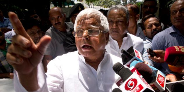 Rashtriya Janata Dal (RJD) leader Lalu Prasad Yadav speaks to reporters after a meeting with Samajwadi Party (SP) leader Mulayam Singh Yadav in New Delhi, India, Friday, May 22, 2015. The leaders reportedly met to sort out seat sharing issues ahead of the Bihar state elections, expected later this year. (AP Photo/Saurabh Das)