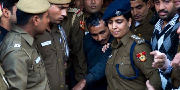 32-year-old Shiv Kumar Yadav, center, a driver from the international taxi-booking service Uber, is surrounded by police as he is brought out after being produced in a court in New Delhi, India, Monday, Dec. 8, 2014. The court ordered Yadav be held for three days for police questioning over allegations that he raped a finance company employee after being hired to ferry her home from a dinner engagement on Friday night. (AP Photo/Saurabh Das)