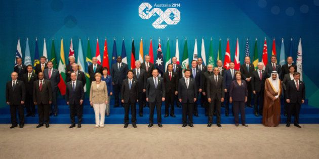 BRISBANE, AUSTRALIA - NOVEMBER 15: In this handout photo provided by the G20 Australia, (Front row L-R) Russia's President Vladimir Putin, South Africa's President Jacob Zuma, France's President Francois Hollande, Germany's Chancellor Angela Merkel, Japan's Prime Minister Shinzo Abe, Australia's Prime Minister Tony Abbott, China's President Xi Jinping, United States' President Barack Obama, Brazil's President Dilma Rousseff, Saudi Arabia's Crown Prince Salman bin Abdulaziz, Turkey's Prime Minister Ahmet Davutoglu, (middle row L-R) Mexico's President Enrique Pena Nieto, Spain's President of the Government Mariano Rajoy Brey, European Commission President Jean-Claude Juncker, Republic of Korea's President Park Geun-hye, Canada's Prime Minister Stephen Harper, Indonesia's President Joko Widodo, United Kingdom's Prime Minister David Cameron, India's Prime Minister Narendra Modi, Italy's Prime Minister Matteo Renzi, European Council President Herman Van Rompuy, Argentina's Minister of Economy Axel Kicillof, (back Row L-R) FSB Chairman Mark Carney, International Labour Organization Guy Ryder, IMF Managing Director Christine Lagarde, OECD Secretary-General Angel Gurria, Senegal's President Macky Sall, Singapore's Prime Minister Lee Hsien Loong, New Zealand's Prime Minister John Key, Mauritania's President Mohamed Ould Abdel Aziz, Myanmar's President U Thein Sein, World Bank Group President Jim Yong Kim, WTO Director-General Roberto Azevedo and United Nations' Secretary-General Ban Ki-moon pose for a group photo during the G20 Leaders Summit on November 15, 2014 in Brisbane, Australia. World leaders have gathered in Brisbane for the annual G20 Summit and are expected to discuss economic growth, free trade and climate change as well as pressing issues including the situation in Ukraine and the Ebola crisis. (Photo by Andrew Taylor/G20 Australia via Getty Images)