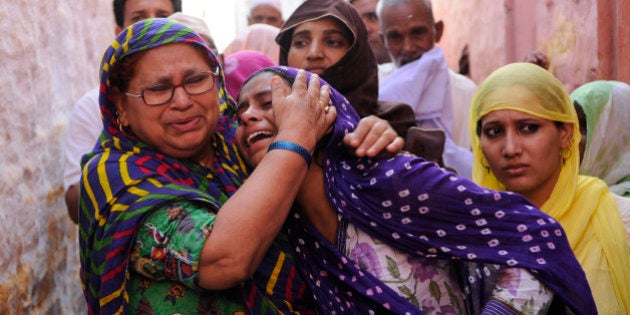 GREATER NOIDA, INDIA - SEPTEMBER 29: Family members of Mohammad Akhlaq (50-year-old man) mourn during his funeral at their village in Bisada on September 29, 2015 in Greater Noida, India. Akhlaq was beaten to death and his son critically injured by a mob over an allegation of storing and consuming beef at home, late night on Monday, in UPs Dadri. Police and PAC were immediately deployed in the village to maintain law and order. Six persons were arrested in connection with the killing of man. (Photo by Burhaan Kinu/Hindustan Times via Getty Images)