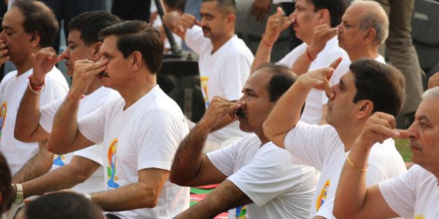 NEW DELHI, INDIA - JUNE 21: Indian Army Chief General Dalbir Singh Suhag, Air Chief Marshal Arup Raha, Navy Chief Admiral RK Dhowan participate in mass yoga session led by Prime Minister Narendra Modi (not seen in the picture) to mark the International Day of Yoga at Rajpath on June 21, 2015 in New Delhi, India. An estimated 40,000 people participated in the celebrations at Rajpath, with around two billion people taking part across the world. The yoga celebrations are being organised after the United Nations had in December last year declared June 21 as International Yoga Day. (Photo by Arvind Yadav/Hindustan Times via Getty Images)