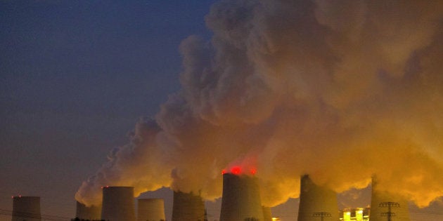 Vapor escapes from cooling towers at the lignite coal-fired power plant operated by Vattenfall AB, in Janschwalde, Germany, on Thursday, Dec. 4, 2014. Germany seeks to meet a national climate target of a reduction in carbon emissions of 40 percent from 1990 levels by 2020. Photographer: Krisztian Bocsi/Bloomberg via Getty Images