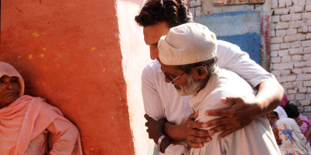 GREATER NOIDA, INDIA - SEPTEMBER 29: Family members of Mohammad Akhlaq (50-year-old man) mourn during his funeral at their village in Bisada on September 29, 2015 in Greater Noida, India. Akhlaq was beaten to death and his son critically injured by a mob over an allegation of storing and consuming beef at home, late night on Monday, in UPs Dadri. Police and PAC were immediately deployed in the village to maintain law and order. Six persons were arrested in connection with the killing of man. (Photo by Burhaan Kinu/Hindustan Times via Getty Images)