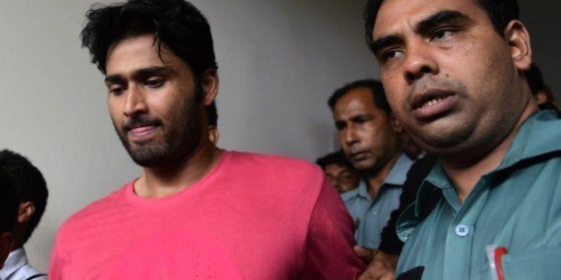 Bangladeshi security personnel escort fugitive cricketer Shahadat Hossain (C) after he surrendered in Dhaka on October 5, 2015. Hossain was remanded in jail on October 5 shortly after he surrendered to a court over allegations of beating his 11-year-old maid, his lawyer said. AFP PHOTO / MUNIR UZ ZAMAN (Photo credit should read MUNIR UZ ZAMAN/AFP/Getty Images)