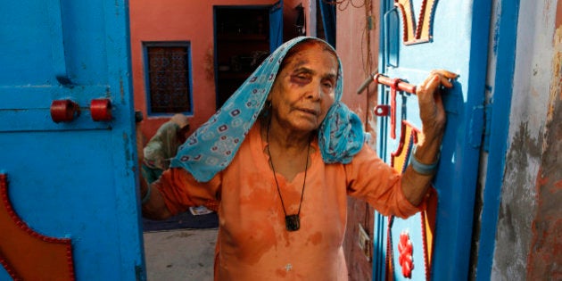 A bruised Asgari Begum, mother of 52-year-old Muslim farmer Mohammad Akhlaq, stands by the entrance of her home in Bisara, a village about 45 kilometers (25 miles) southeast of the Indian capital of New Delhi, Wednesday, Sept. 30, 2015. Indian police arrested eight people and were searching Wednesday for two more after villagers allegedly beat Akhlaq to death and severely injured his son upon hearing rumors that the family was eating beef, a taboo for many among Indiaâs majority Hindu population. Since Prime Minister Narendra Modi, a Hindu nationalist, took office last year, hard-line Hindus have been demanding that India ban beef sales, a key industry for many within India's poor, minority Muslim community. In many Indian states, the slaughtering of cows and selling of beef are either restricted or banned. (AP Photo/Manish Swarup)