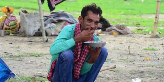 ALLAHABAD, UTTAR PRADESH, INDIA - 2015/07/15: An Indian homeless man eats food in front of his shelter in Allahabad. The United Nation's MGD in 2000 aimed to free millions from extreme poverty and hunger, illiteracy, poor health; however, bout 30 crore people still live in extreme poverty in India despite the Millennium Development Goal (MGD) programme expiring in December, a United Nations report has said. (Photo by Prabhat Kumar Verma/Pacific Press/LightRocket via Getty Images)