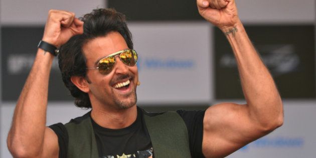 Indian Bollywood actor, Hrithik Roshan gestures as he arrives on stage to launch the Windows platform based game Krrish 3 at a college in Bangalore on October 7, 2013. The game developed by Hungama Digital Media Entertainment and Gameshastra is based on the yet to be released Bollywood movie 'Krrish 3' in which Hrithik Roshan plays superhero. AFP PHOTO/ Manjunath KIRAN (Photo credit should read Manjunath Kiran/AFP/Getty Images)