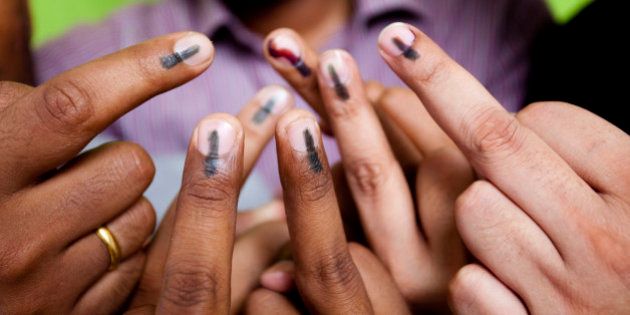 Indian youths showing their mark after voting in the General Elections in India. This mark is an indication that the person has cast it's Vote