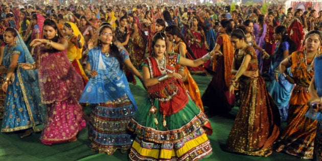 INDORE, INDIA - SEPTEMBER 25: Girls take part in Garba dance on the first day of Navratri festival near Madan Mahal garden on September 25, 2014 in Indore, India. Hindu festival of Navratri is observed twice a year, once in the beginning of summer and again at the onset of winter. Navratri means nine nights during which nine forms of Goddess/ Shakti/Devi are worshiped. (Photo by Amit K Jaiswal/Hindustan Times via Getty Images)