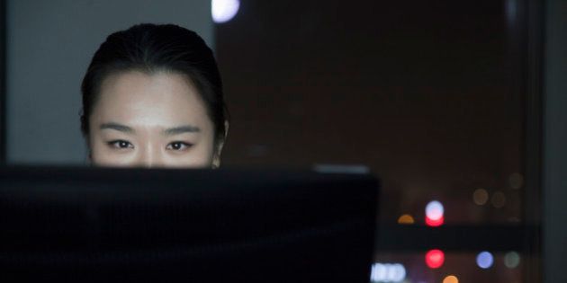Chinese businesswoman working late in office