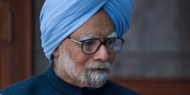 Former Indian prime minister Manmohan Singh, sits with the newly elected office bearers of