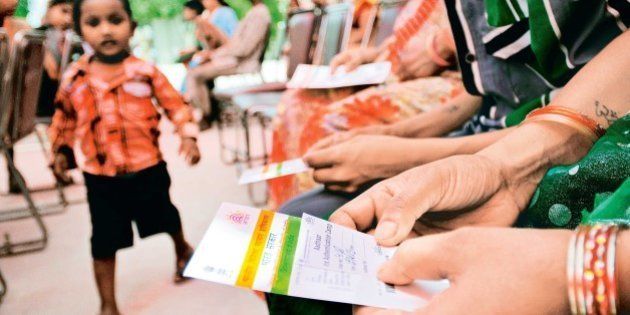 NEW DELHI, INDIA - APRIL 12: People stand in queue during Aadhar card camp, pilot project for authentication of UID cards at Kalyanpuri on April 12, 2013 in New Delhi, India. (Photo by Priyanka Parashar/Mint via Getty Images)