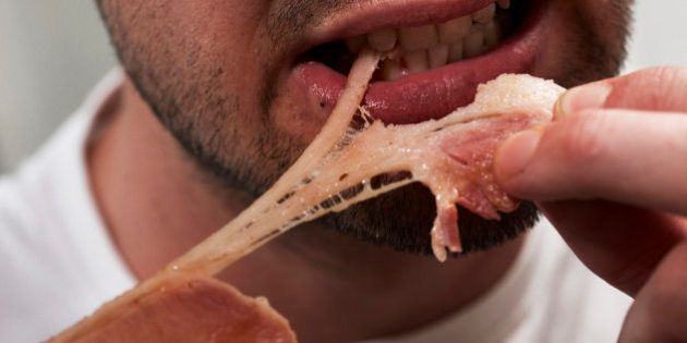 Man eating bacon