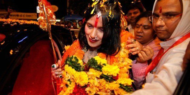 MUMBAI, INDIA - AUGUST 27: (file photo) Radhe Maa, self-proclaimed Godwoman, visits Siddhivinayak Temple, Prabhadevi, on August 27, 2012 in Mumbai, India. Radhe Maa has been accused of dowry harassment by a woman, who has filed an FIR or police complaint in Mumbai. The woman has said that her husband's family tortured her on the Godwoman's advice and forced her to serve Radhe Maa, do chores for her and give her massages. Radhe Maa's real name is Sukhvinder Kaur. She was born on 4 April 1965 in Dorangala village of Gurdaspur district in Punjab. Her followers state that she was drawn to spirituality as a child, and spent a lot of time at the Kali temple in her village. However, according to the people of her village, she did not show any spiritual leanings as a child. At the age of 23, she became a disciple of Mahant Ram Deen Das of 1008 Paramhans Bagh Dera Mukerian in Hoshiarpur district. Ram Deen Das oversaw her deeksha (initiation ceremony), and gave her the title Radhe Maa. She is usually seen in glittering red bridal wear, heavy jewellery and layers of make-up. Thick garlands and a trident complete the picture. She used to stitch clothes to support her husband's small income. (Photo by Vijayanand Gupta/Hindustan Times via Getty Images)