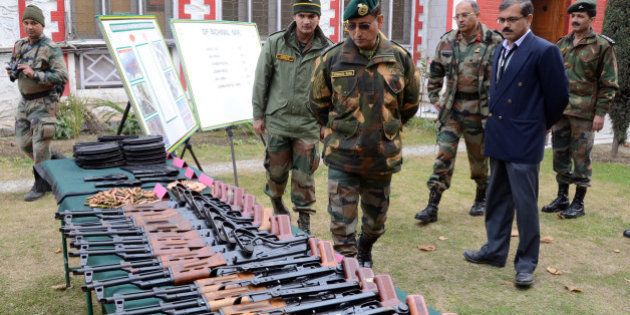 SRINAGAR, KASHMIR, INDIA - NOVEMBER 24: Lieutenant General Subrata Saha of Indian Army inspects seized arms and ammunitions , recovered by them in Kupwara near the ceasefire line or Line of Control (LoC) that divides Kashmir between India and Pakistan, at Chinar corps headquarter on November 24, 2014, in Srinagar, the summer capital of Indian administered Kashmir, India. The Indian army claimed to have recovered arms and ammunition from a suspected militant hideout on Sunday in the forest area of Kupwara district near LoC of poll-bound Indian administered Kashmir. Amid tight security, more than five million people will cast their votes in the coming assembly elections in the strife torn Jammu and Kashmir, even as most pro-independence groups have asked people to boycott the five phased polls starting on November 25 and ending on December 20. The votes will be counted on December 23. (Photo by Yawar Nazir/Getty Images