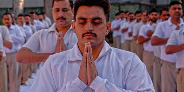 SRINAGAR, KASHMIR, INDIA - JUNE 19: Indian Paramilitary soldiers of Central Reserve Police Force (CRPF) perform Yoga exercise in their camp on June 19, 2015, in Srinagar, the summer capital of Indian administered Kashmir, India. Indian troopers perform Yoga exercise in their camp, two days ahead of the first International Day of Yoga to be held on June 21, after approved by the United Nations on Indian Prime Minister Narendra Modi's suggestion. India has close to a million soldiers posted in Kashmir, making the disputed Himalayan region one of the most militarized zones in the world. The ongoing conflict has taken a heavy toll on the mental health of the Indian armed forces prompting New Delhi to take slew of measures to control the stress among its forces. Yoga is one of the measure the Indian Defence Ministry has taken to reduce the stress of its forces battling militancy in Indian controlled Kashmir . (Photo by Yawar Nazir/ Getty Images)