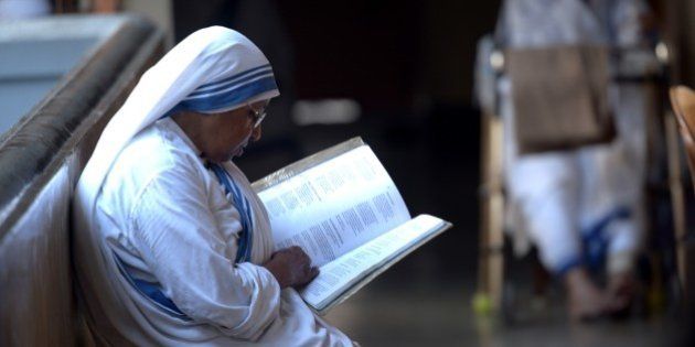 Indian nuns from the Catholic Order of the Missionaries of Charity take part in a mass to commemorate the 105th birthday of Mother Teresa at the Indian Missionaries of Charity house in Kolkata on August 26, 2015. Mother Teresa, a Nobel peace prize winner and Roman Catholic saint-in-waiting, was born on August 26, 1910 to Albanian parents in what is now Skopje in Macedonia. AFP PHOTO/Dibyangshu SARKAR (Photo credit should read DIBYANGSHU SARKAR/AFP/Getty Images)