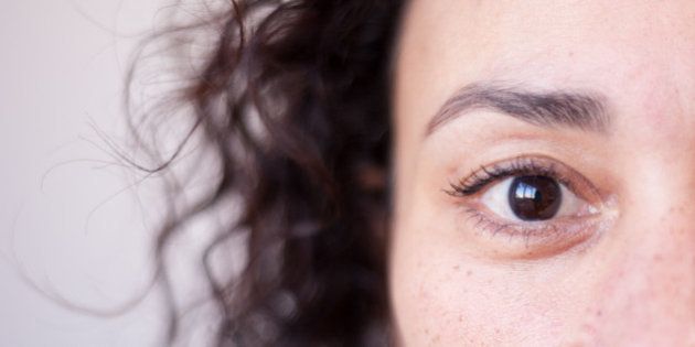 Close up of a woman's brown eye, strong selective focus