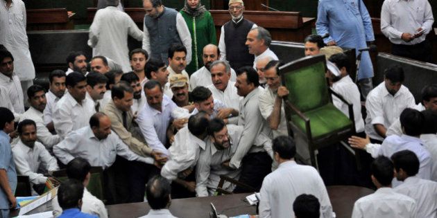 State lawmakers of the opposition People's Democratic Party scuffle with staff members of the house after a controversial bill was passed in the Jammu and Kashmir Assembly in Jammu, India, Friday, April 9, 2010. According to the new bill, an educated youth can now apply for government jobs only in his own district whereas a youth belonging to lower castes can apply for the same in any of 22 district in the state including Kashmir valley, according to a news agency. (AP Photo)