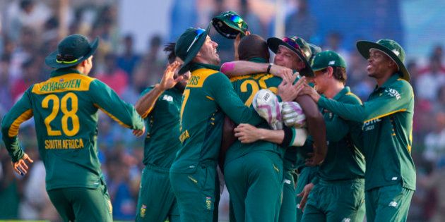 South African cricketers surround Kagiso Rabada, center, who took crucial wickets of India to swing the match towards South Africa in the last few overs during the first one day international cricket match between them in Kanpur, India, Sunday, Oct. 11, 2015. South Africa won by 5 runs. (AP Photo/Saurabh Das)
