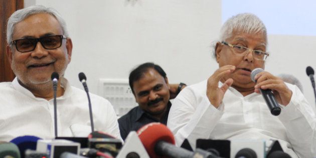 PATNA, INDIA - AUGUST 12: Bihar Chief Minister and JD(U) leader Nitish Kumar with RJD Chief Lalu Yadav addressing a joint press conference to announce Maha Gathbandhan on August 12, 2015 in Patna, India. The RJD and JD-U announced that they will contest 100 seats each in the Bihar assembly election, leaving 40 seats to the Congress and three to the NCP. (Photo by AP Dube/Hindustan Times via Getty Images)