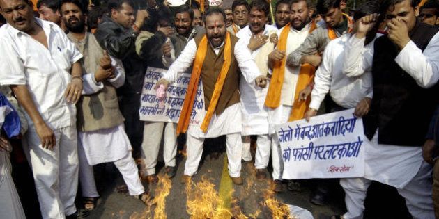 NEW DELHI, INDIA: Indian activists from the Hindu right-wing Shiv Sena burn an effigy of an Islamic militant during a protest march on the second anniversary of the attack on India's Parliament building in New Delhi, 13 December 2003. Some six suspected militants forced their way past security guards at the Indian parliament on 13 December 2001, during which a shootout with security forces left 14 people dead. AFP PHOTO/RAVEENDRAN (Photo credit should read RAVEENDRAN/AFP/Getty Images)