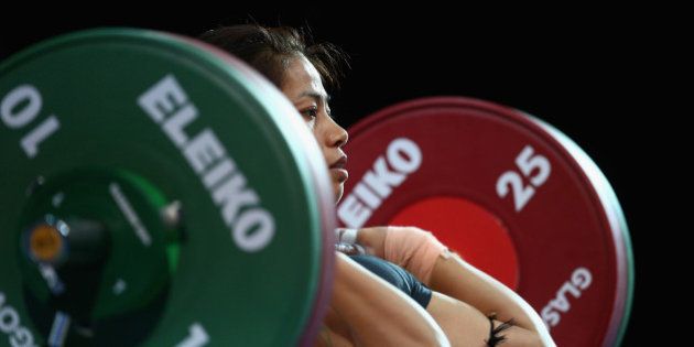 GLASGOW, SCOTLAND - JULY 24: Sanjita Chanu Khumukcham of India competes in the Clean and Jerk on her way to winning the Gold Medal in the Women's 48kg Weightlifting at the Scottish Exhibition And Conference Centre during day one of the Glasgow 2014 Commonwealth Games on July 24, 2014 in Glasgow, United Kingdom. (Photo by Paul Gilham/Getty Images)