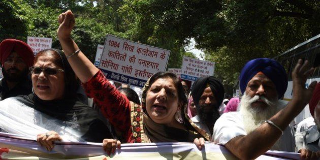 Indian Sikh women shout slogans against the Congress party of India and its President Sonia Gandhi during a protest in New Delhi on June 5, 2015. The protest was taken against Congress Party leader Jagdish Tytler's alleged role in the 1984 anti-Sikh riots. AFP PHOTO/ MONEY SHARMA (Photo credit should read MONEY SHARMA/AFP/Getty Images)