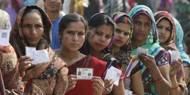 NEW DELHI, INDIA - FEBRUARY 7: Women in queue to cast their vote at Tughlakabad polling station, during the Delhi Assembly Elections 2015, on February 7, 2015 in New Delhi, India. Delhi is headed for a record turnout on Saturday as more than 69.5% of the city's 1.33 crore voters cast their ballot till 5pm. After a slow start in the morning, polling picked up around noon, with scores of people queuing up at booths to exercise their franchise in an electrifying electoral battle that the national capital has never witnessed before. 69.5 per cent of 1.3 voters had been inked by 5 pm on Saturday, as Delhi looked set for a record turnout after a slow morning. There are 673 candidates in the fray now. Voting is taking place in 11,763 centers, located in schools. Many initial voters in middle class and posh areas were early morning walkers. (Photo by Raj K Raj/Hindustan Times via Getty Images)