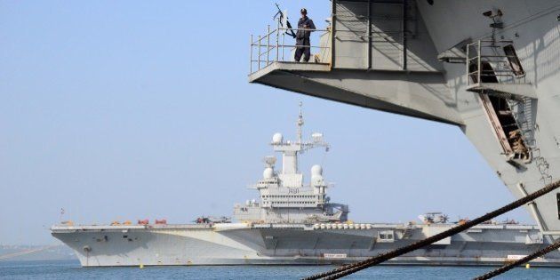In this photograph taken on April 25, 2015, an Indian sailor stands alert on INS Viraat as France's aircraft carrier Charles de Gaulle (REAR) lies off the Indian coast at Goa, ahead of the start of the Indo-French Naval exercise 'Varuna 2015'. 'Varuna 2015' will take place between April 28 and May 3 in the Arabian Sea off the Indian coast. AFP PHOTO/STR (Photo credit should read STRDEL/AFP/Getty Images)