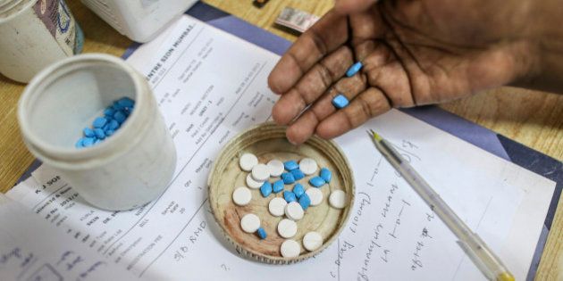 Surendra Achrekar, a paramedical worker for the Bombay Leprosy Project (BLP), counts tablets for a prescription inside the dispensary of the organization's referral center in Mumbai, India, on Tuesday, Sept. 10, 2013. While leprosy, described in Indian texts from the 6th century BC, has been cleared from the developed world, its regaining ground in India, which has become the biggest source of cases imported into the U.K. and Australia. Photographer: Dhiraj Singh/Bloomberg via Getty Images