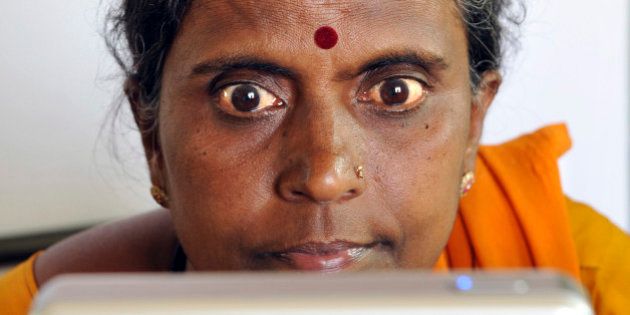 An Indian villager opens up her eyes for iris scanning infront of an Iris Access machine during the data collecting process for a pilot project of The Unique Identification Authority of India (UIDAI) in the village of Chellur, some 145kms north-west of Bangalore on April 22, 2010. The Unique Identification Authority of India (UIDAI) has been created as an attached office under the Planning Commission. Its role is to develop and implement the necessary institutional, technical and legal infrastructure to issue Unique Identity (UID) numbers to Indian residents.The scheme which will be equivalent of the social security number in the US is designed to leverage intensive usage of the UID for multiple purposes to provide an efficient and convenient mechanism to update information. Photographs and biometric data will be added progressively to make the identification foolproof. Easy registration and information change procedures are envisaged for the benefit of the people. AFP PHOTO/Dibyangshu SARKAR (Photo credit should read DIBYANGSHU SARKAR/AFP/Getty Images)