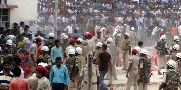 NALANDA, INDIA - OCTOBER 13: Policemen use lathcharge to quell crowd after they started pelting stones over late arrival of Bollywood actor Ajay Devgn at an election rally for the ongoing Bihar Assembly Elections on October 13, 2015 in Nalanda, India. Around 12 people, including some policemen, were injured in the incident. The actor, who was supposed to address the meeting for BJP candidate Sunil Kumar, finally waved at the crowd from the helicopter and did not land. (Photo by Hindustan Times via Getty Images)