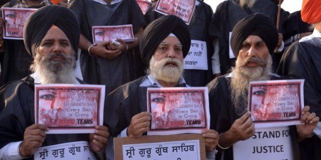 Members of various Sikh organizations hold placards during a 'Punjab bandh' strike in Amritsar on October 15, 2015. Sikh groups called for a strike following protests that have left two people dead in recent days, over the alleged desecration of a Sikh holy book. AFP PHOTO/ NARINDER NANU (Photo credit should read NARINDER NANU/AFP/Getty Images)