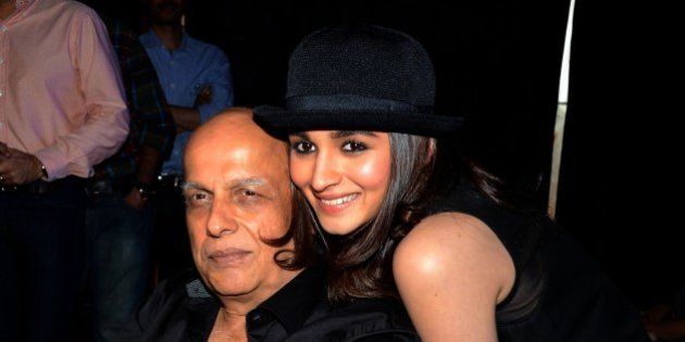 Indian Bollywood film actress Alia Bhatt (R) poses with her father, director Mahesh Bhatt during the song launch of their Hindi film 'Humpty Sharma Ki Dulhania' in Mumbai on July 2, 2014. AFP PHOTO (Photo credit should read STR/AFP/Getty Images)