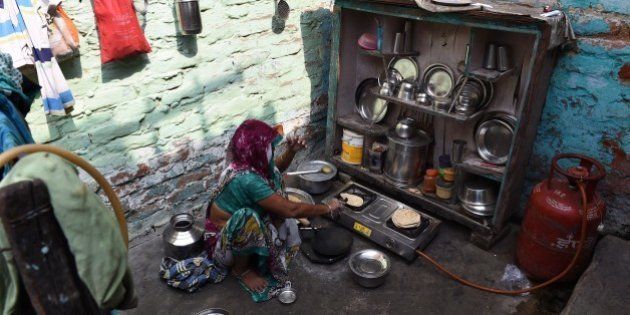 The grandmother of a four-year-old girl who was raped prepares food at her house in a slum in New Delhi on October 13, 2015. Indian police said they have arrested the main suspect in a horrific attack on a four-year-old girl who was raped and slashed with a blade before being abandoned by a railway track. AFP PHOTO / MONEY SHARMA (Photo credit should read MONEY SHARMA/AFP/Getty Images)