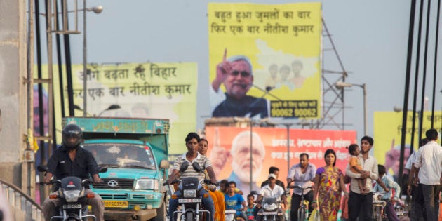 People ride motorcycles over a bridge past election billboard advertisements featuring images of Indian Prime Minister Narendra Modi and other party candidates in Patna, Bihar, India, on Monday, July 27, 2015. More than anywhere, Bihar reflects the challenge Prime Minister Narendra Modi faces in overhauling modern India. A vast, landlocked plain bordering the Himalayan nation of Nepal to the north and bisected by the Ganges, India's holiest river, the state is home to about one in 12 Indians. Photographer: Prashanth Vishwanathan/Bloomberg via Getty Images